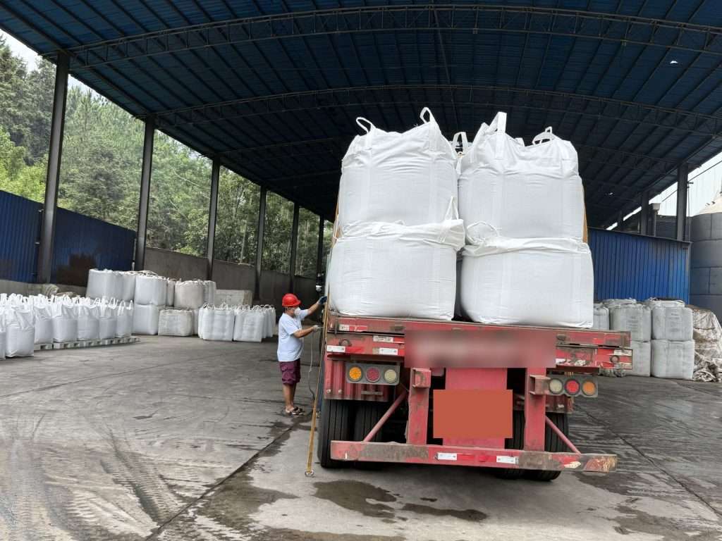 Jumbo bags of lignosulfonate loaded on a flatbed trailer